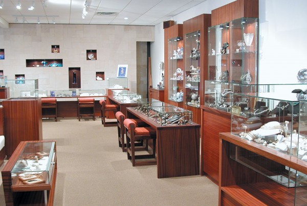 Store interiors and fixtures with elegant wood and glass custom furnishings