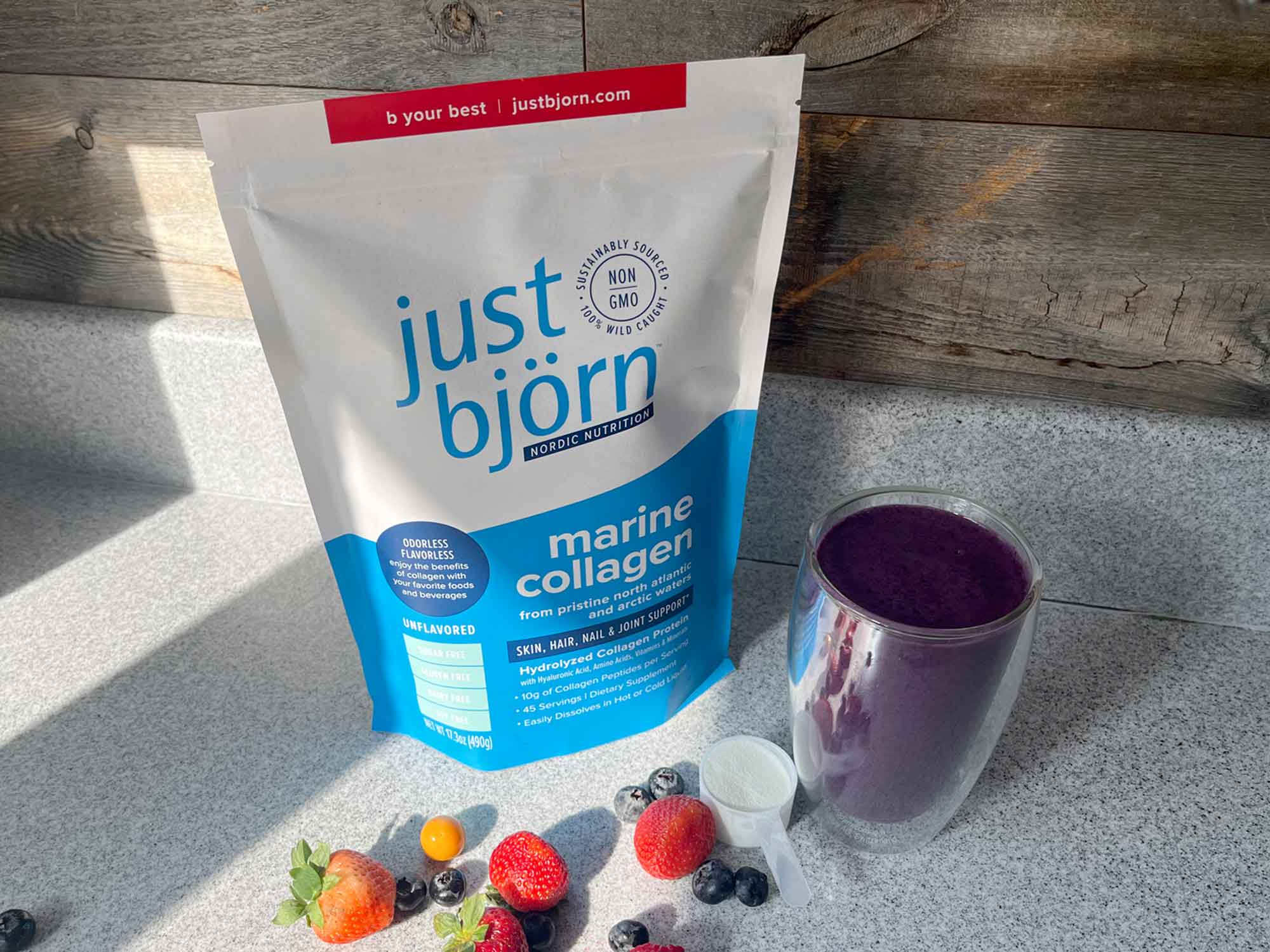 just björn marine collagen with berries and a smoothie on a counter