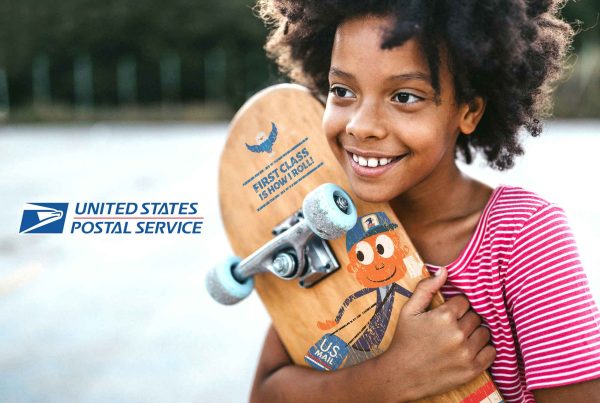 Child holding a skateboard with Mr. Zip on it. USPS Logo