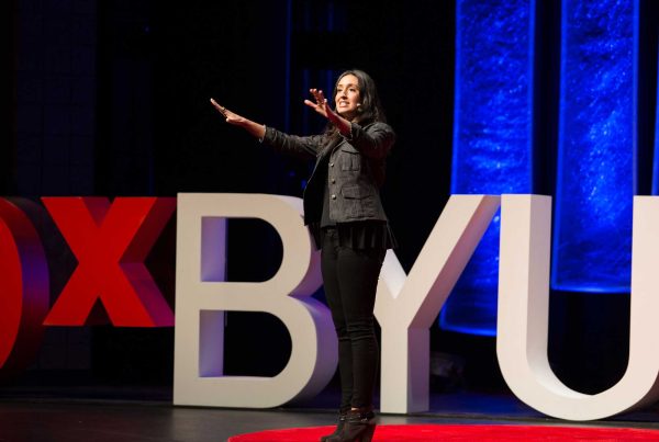 Erica Orange speaking on the stage at TEDx BYU